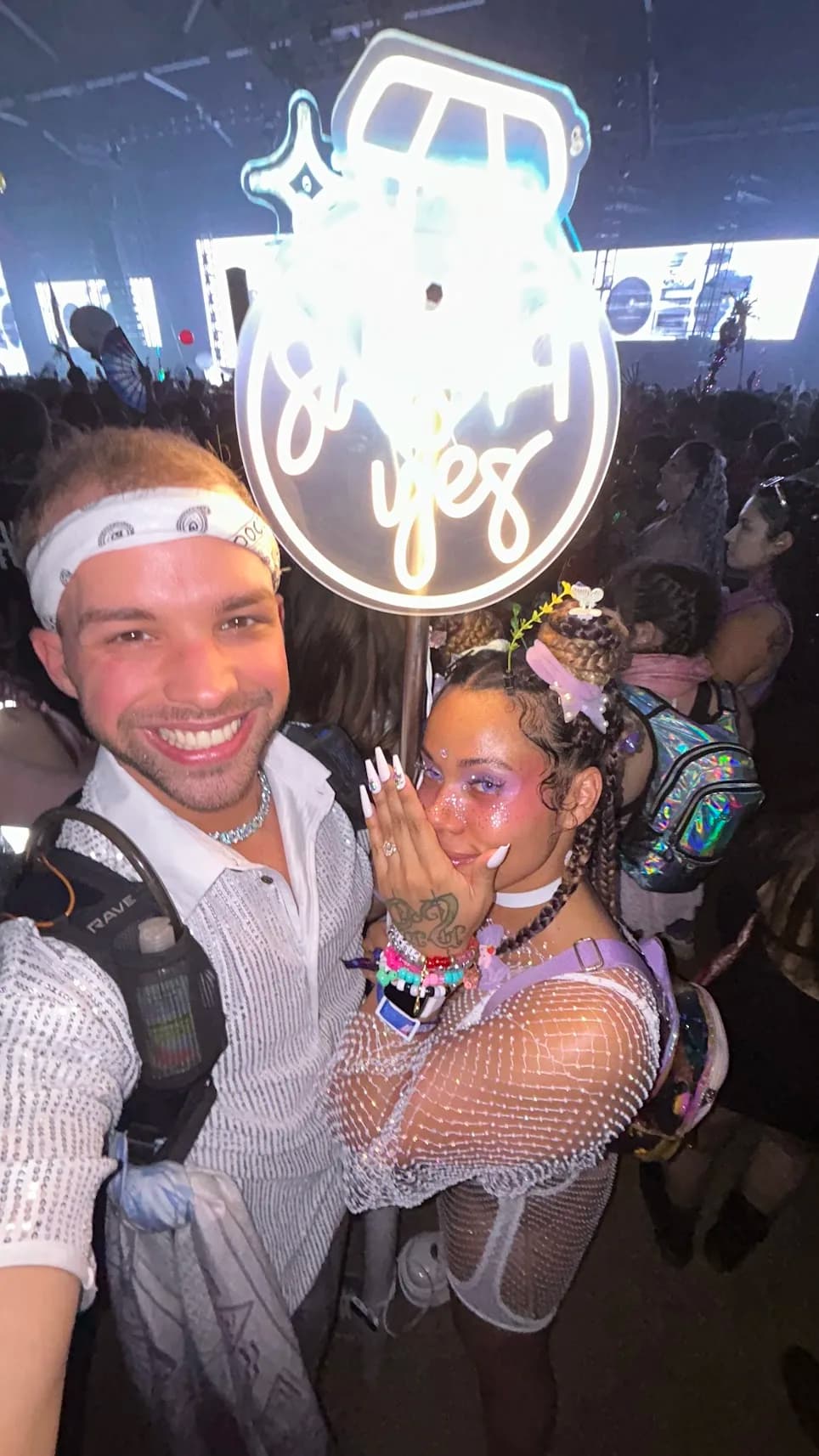 Sean and Eva with the "she said yes" totem right after the proposal in the Marauda moshpit at LAN 2024