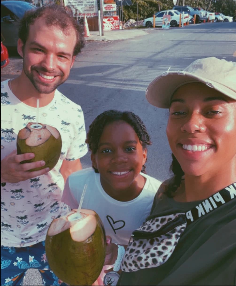 Aubree, Eva, Sean drinking from coconuts in Puerto Rico